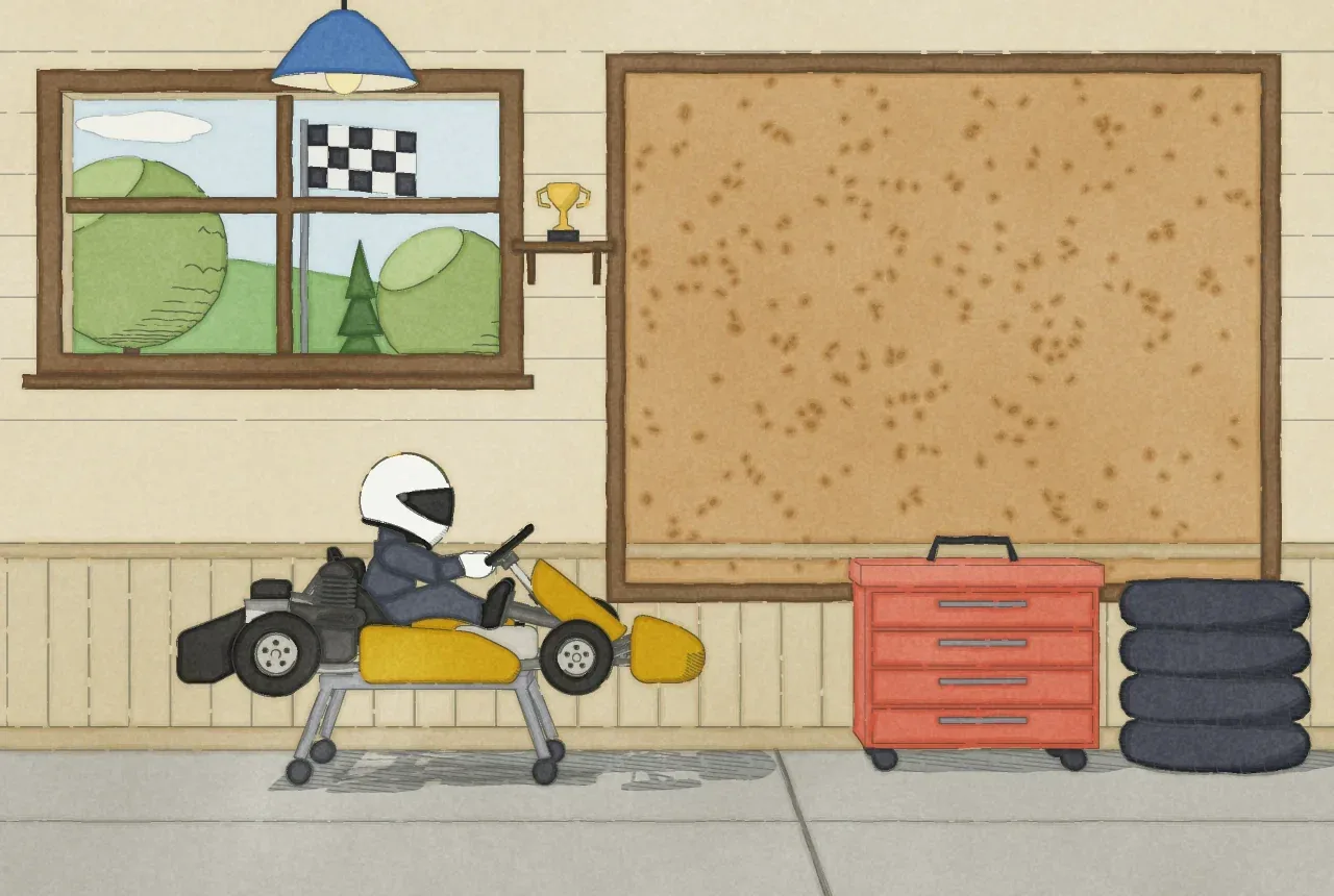 A driver in a yellow kart on a stand in the garage.
